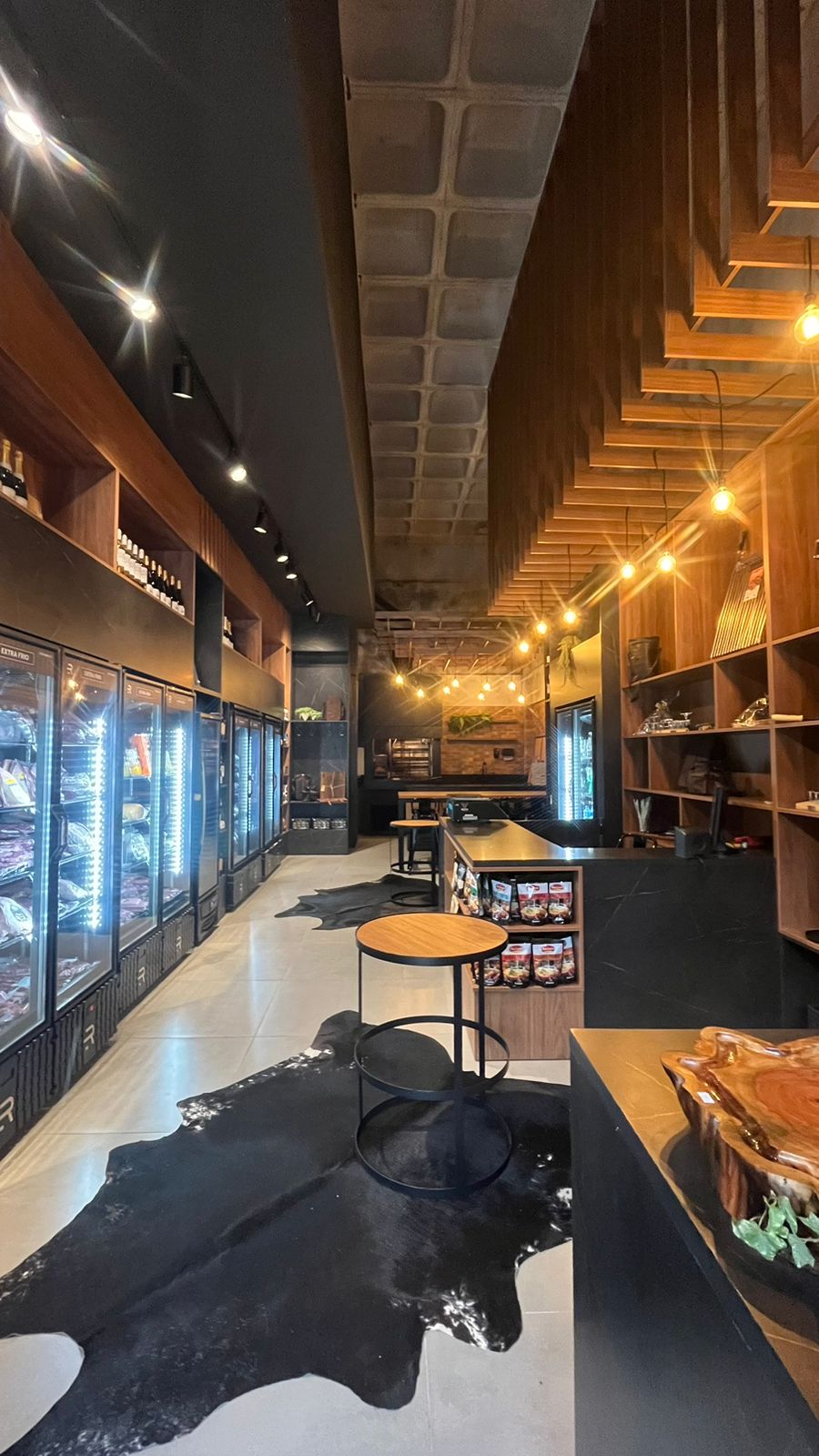 Empório e açougue gourmet com design industrial em madeira e preto